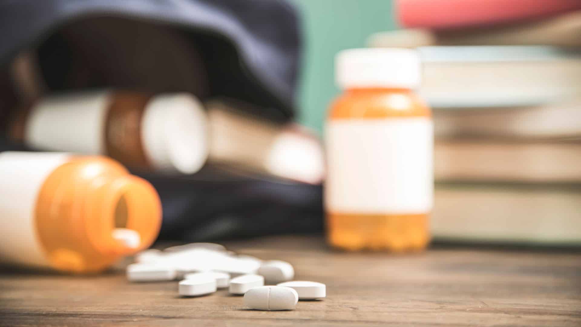 Pills pouring out of a flask