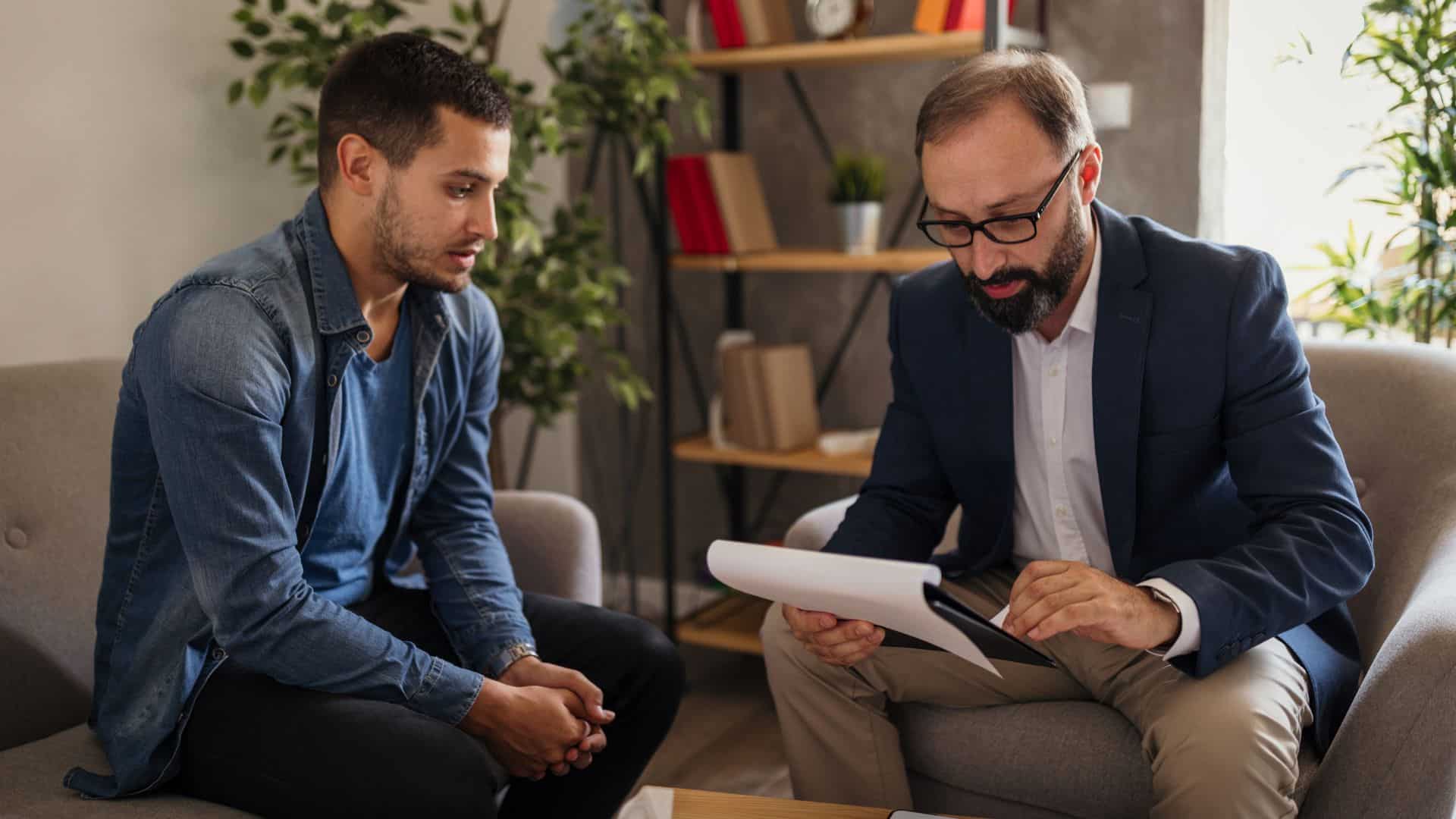 Therapist sitting with a male patient