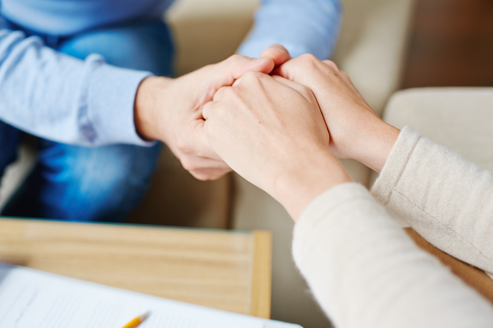 Therapist holding hands with a patient