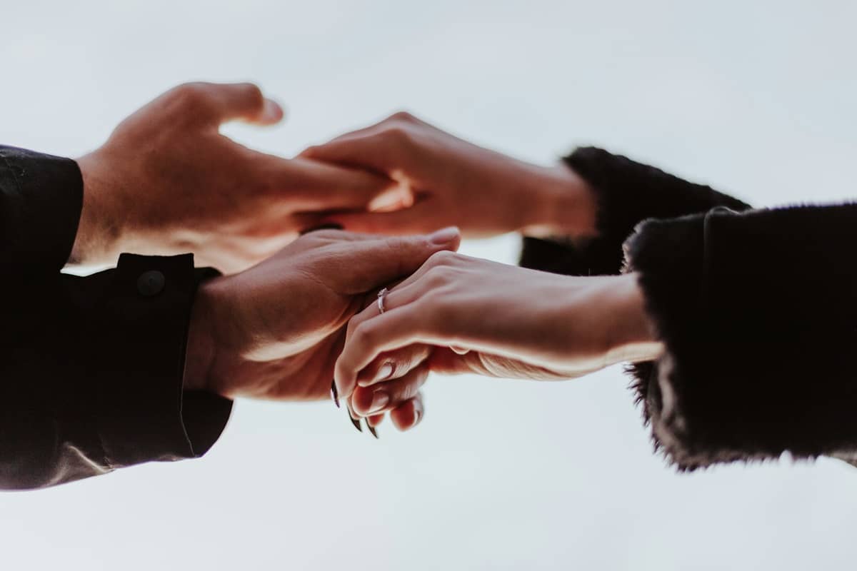 Man and woman holding hands in a close up