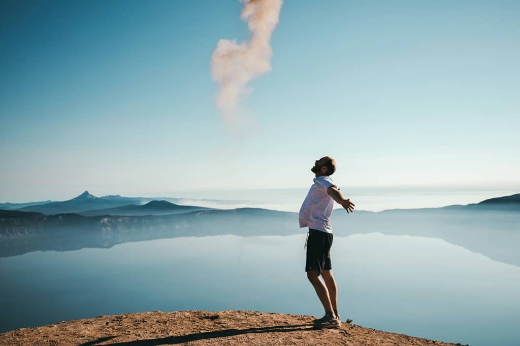 A man embracing the nature on top of a mountain